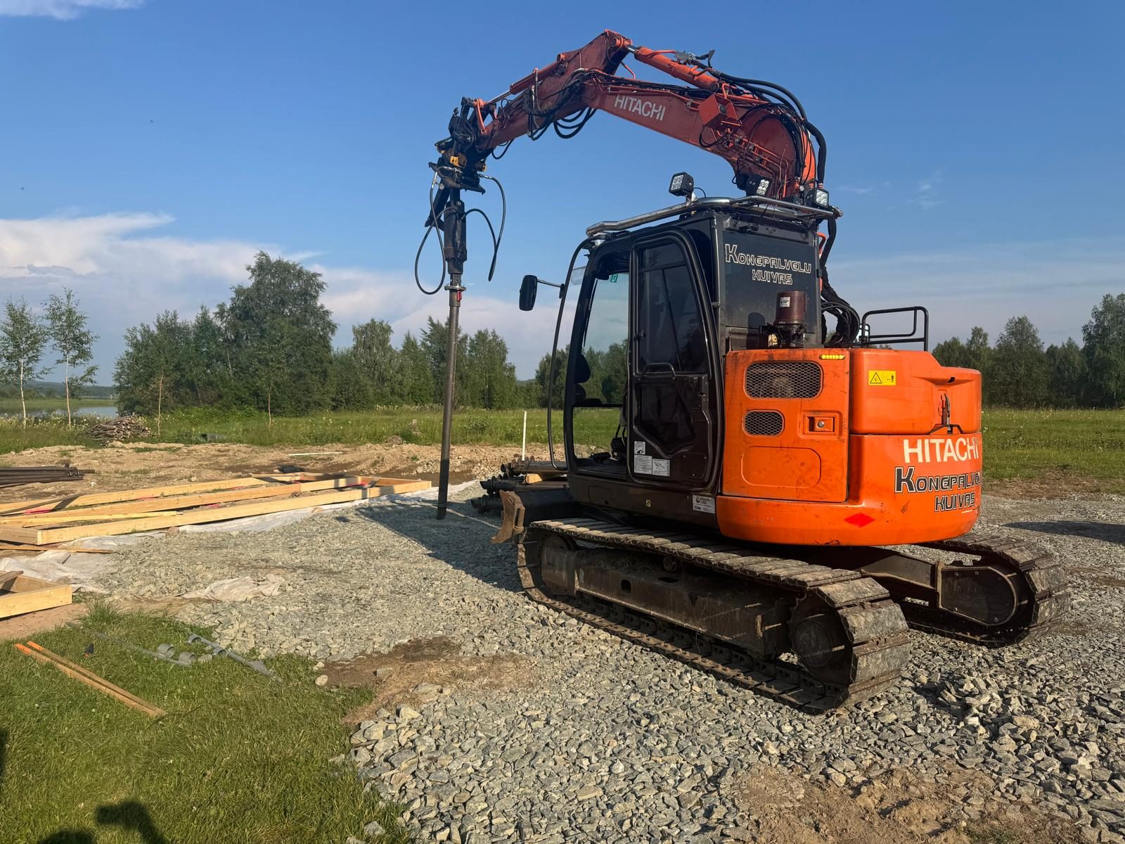 Screw pile foundation for residential homes, excavator on cabin site