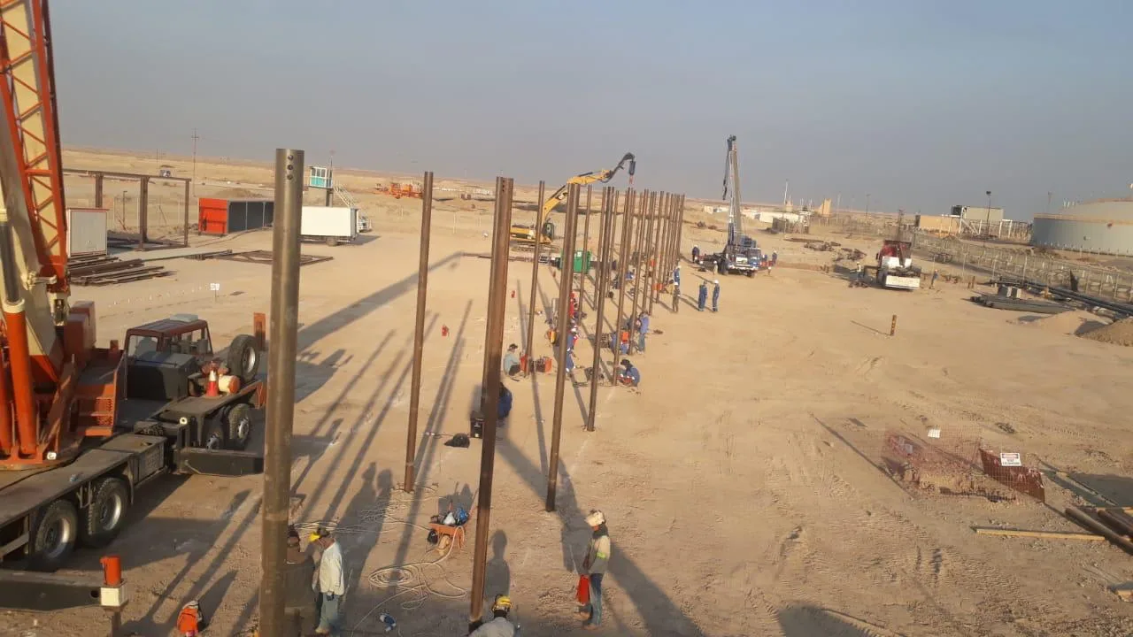 Rows of installed helical screw piles for oil pipeline support structures in Basra, Iraq